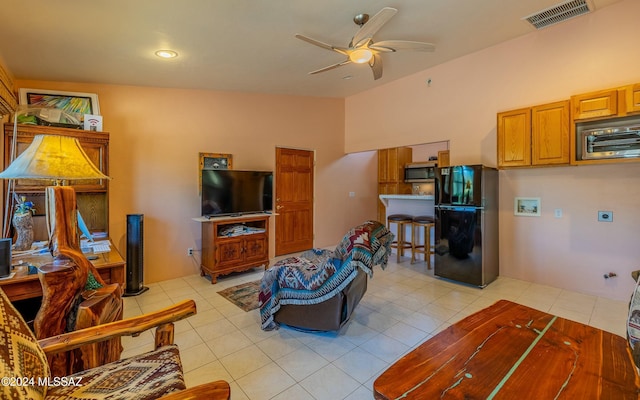 living room with ceiling fan and light tile patterned floors