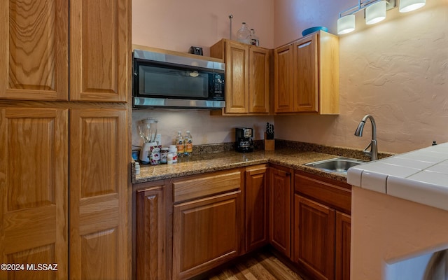 kitchen with sink and dark wood-type flooring