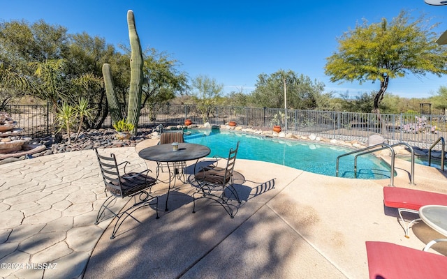 view of swimming pool with a patio