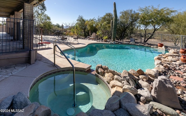 view of pool featuring an in ground hot tub and a patio