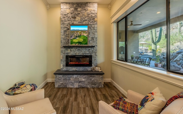 15251 N Dove Canyon Pass, Marana, AZ 85658 - living room featuring a fireplace, ornamental molding, baseboards, wood finished floors, and ceiling fan