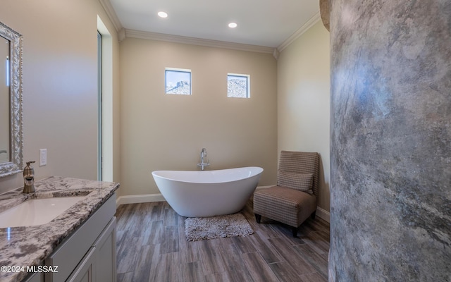 15251 N Dove Canyon Pass, Marana, AZ 85658 - full bath with vanity, ornamental molding, a freestanding bath, wood finished floors, and baseboards