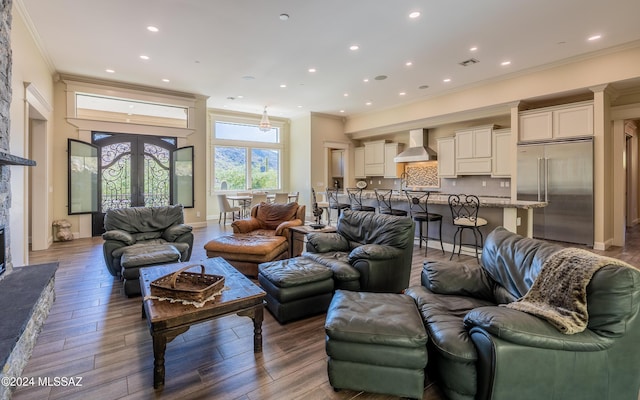 15251 N Dove Canyon Pass, Marana, AZ 85658 - living room featuring ornamental molding, recessed lighting, wood finished floors, and a stone fireplace