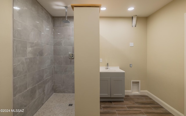 15251 N Dove Canyon Pass, Marana, AZ 85658 - bathroom featuring tiled shower, vanity, wood finished floors, recessed lighting, and baseboards