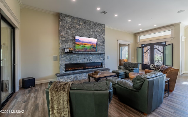 15251 N Dove Canyon Pass, Marana, AZ 85658 - living room with a stone fireplace, wood finished floors, ornamental molding, recessed lighting, and baseboards