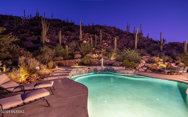 15251 N Dove Canyon Pass, Marana, AZ 85658 - pool at twilight with a patio area and an outdoor pool