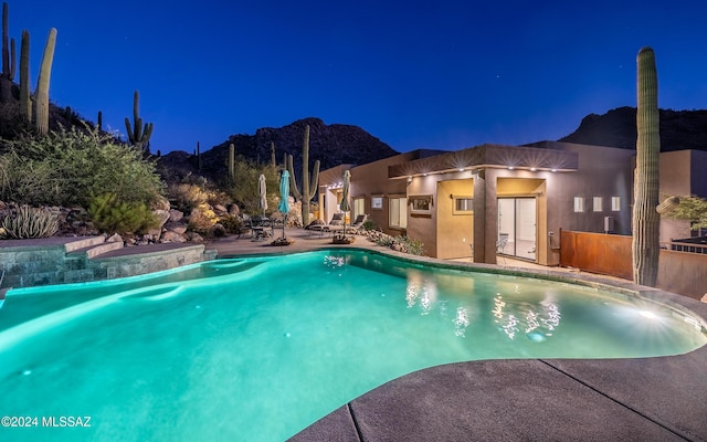 15251 N Dove Canyon Pass, Marana, AZ 85658 - pool at night with a patio and an outdoor pool