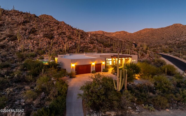 15251 N Dove Canyon Pass, Marana, AZ 85658 - southwest-style home with a mountain view, a garage, driveway, and stucco siding