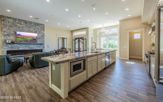 15251 N Dove Canyon Pass, Marana, AZ 85658 - kitchen with stainless steel appliances, ornamental molding, a sink, a kitchen island with sink, and open floor plan