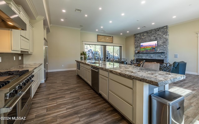 15251 N Dove Canyon Pass, Marana, AZ 85658 - kitchen with wall chimney exhaust hood, premium appliances, crown molding, dark wood-style flooring, and baseboards