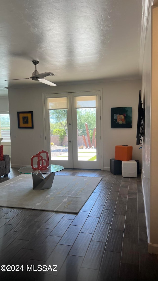 entryway with ceiling fan, plenty of natural light, crown molding, and french doors