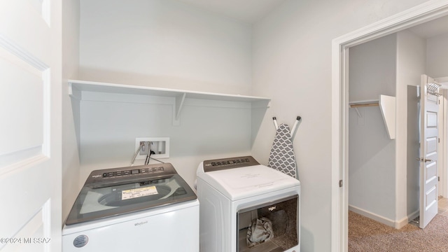 clothes washing area featuring independent washer and dryer and light colored carpet