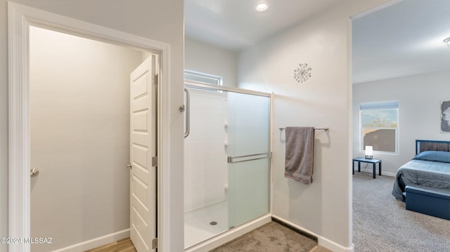 bathroom with a shower with shower door