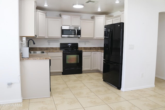 kitchen with white cabinetry, sink, light tile patterned flooring, and black appliances