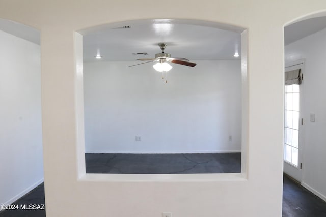 spare room featuring plenty of natural light and ceiling fan