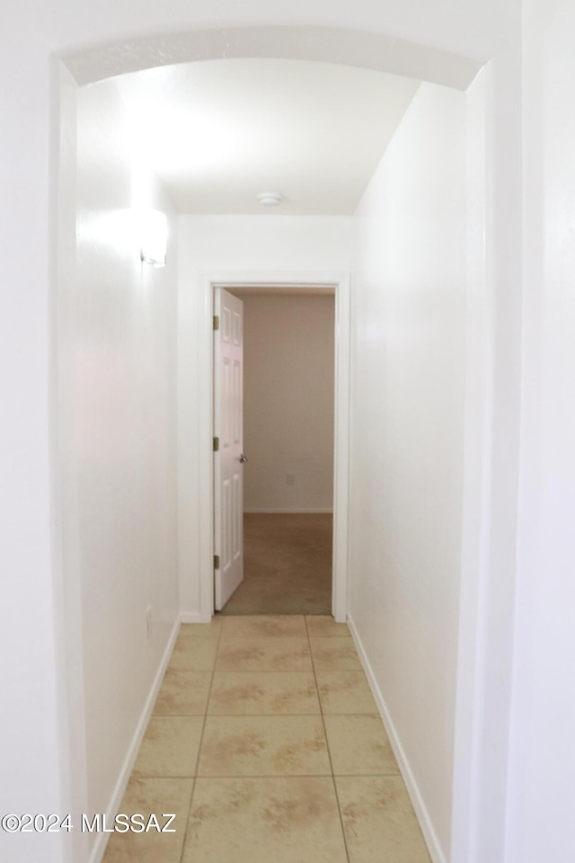 corridor with light tile patterned floors