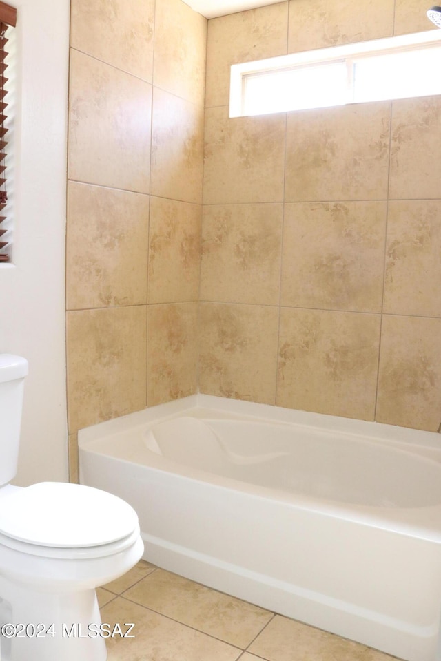 bathroom featuring tile patterned flooring, bathtub / shower combination, and toilet