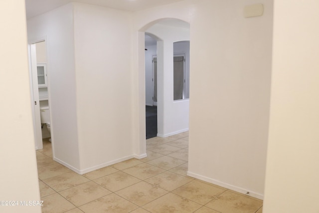 corridor with light tile patterned flooring