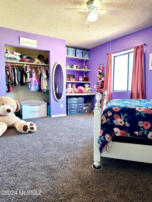 bedroom with a closet, carpet, ceiling fan, and a textured ceiling