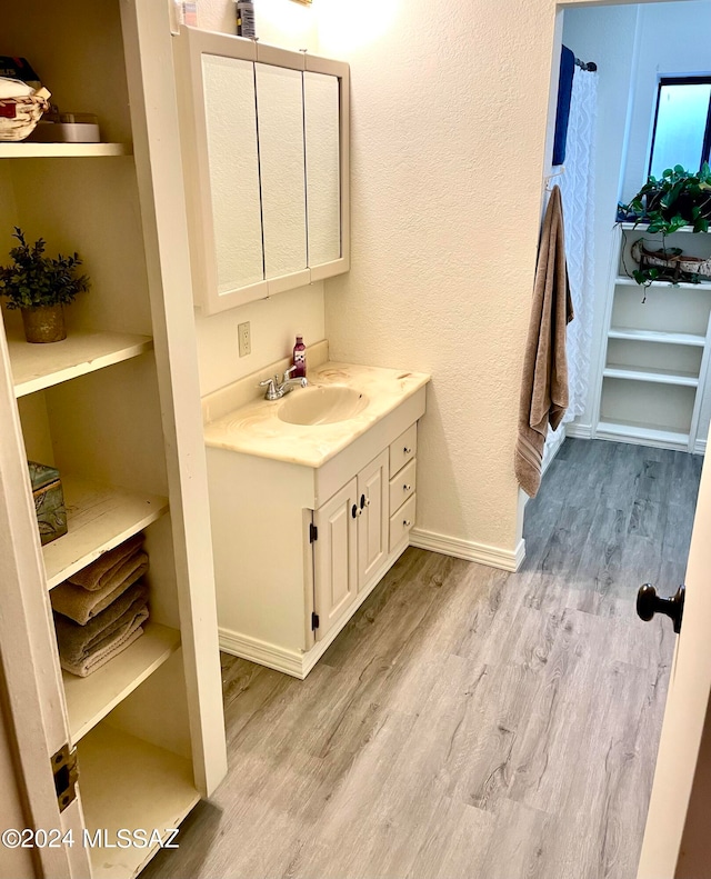 bathroom featuring vanity and hardwood / wood-style flooring