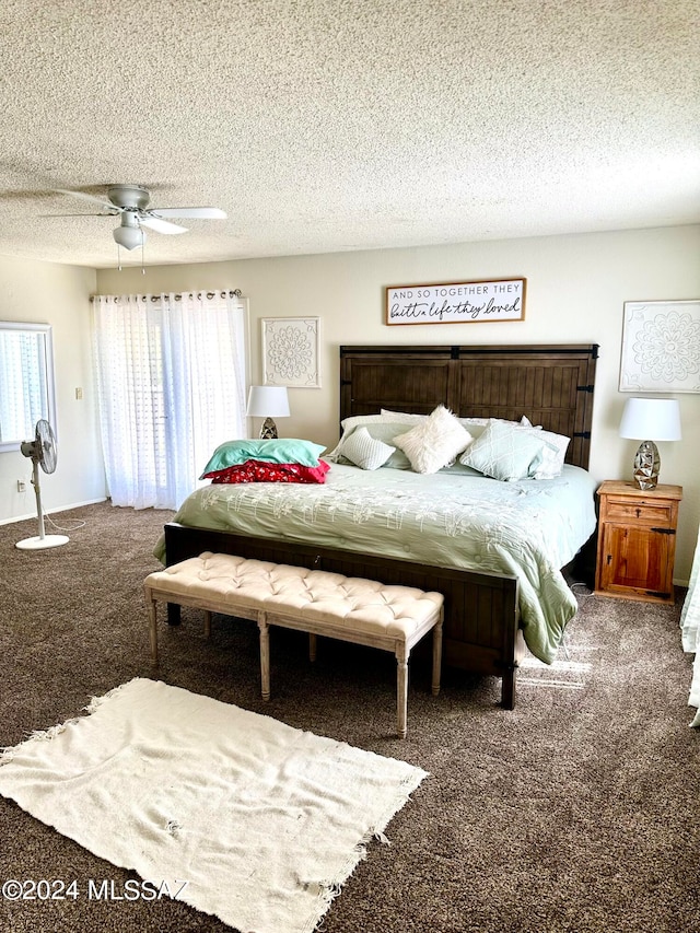 carpeted bedroom with ceiling fan and a textured ceiling