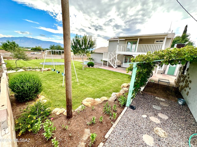 view of yard with a mountain view and a patio