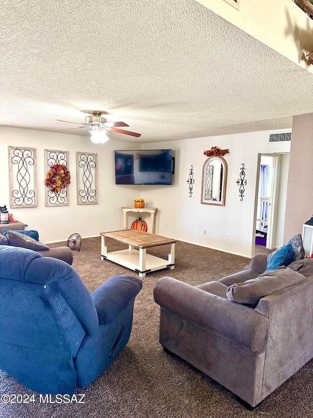 carpeted living room with ceiling fan and a textured ceiling