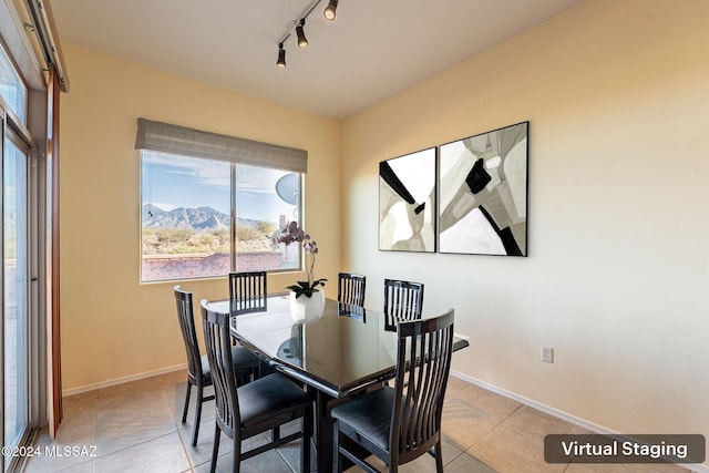 dining area featuring a mountain view and light tile patterned floors