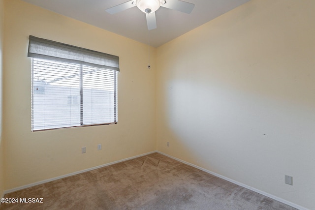 carpeted spare room featuring ceiling fan