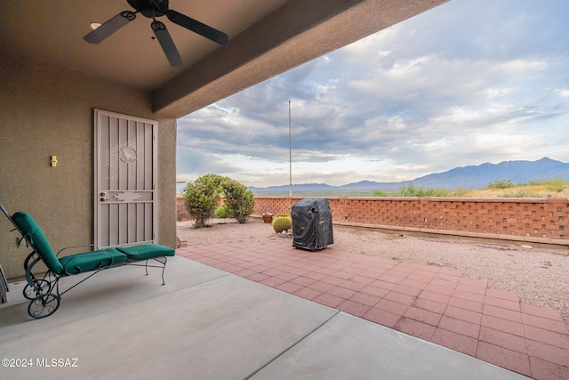 view of patio / terrace featuring a mountain view, area for grilling, and ceiling fan