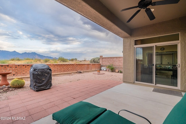 view of patio featuring a mountain view, grilling area, and ceiling fan