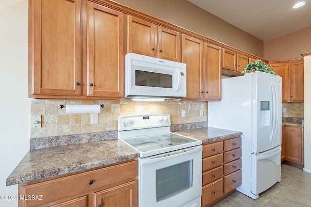 kitchen with decorative backsplash, stone countertops, white appliances, and light tile patterned floors