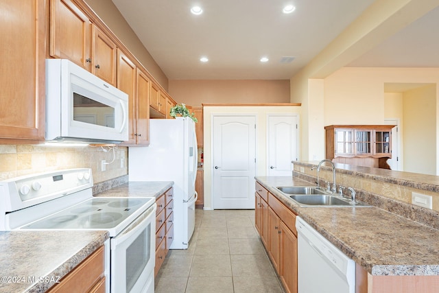 kitchen with sink, tasteful backsplash, an island with sink, white appliances, and light tile patterned flooring