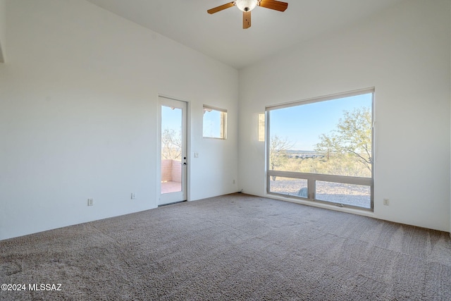 carpeted spare room with high vaulted ceiling and ceiling fan