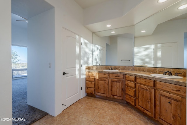 bathroom featuring tile patterned flooring, vanity, and ceiling fan