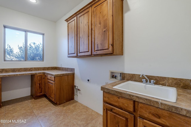 clothes washing area featuring washer hookup, electric dryer hookup, cabinets, and sink