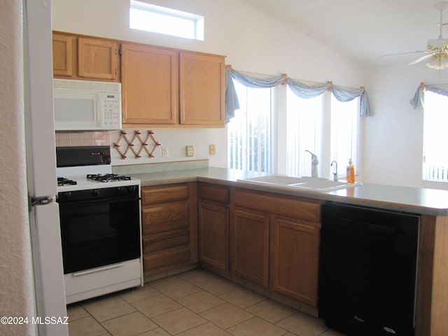 kitchen with sink, lofted ceiling, white appliances, backsplash, and light tile patterned floors