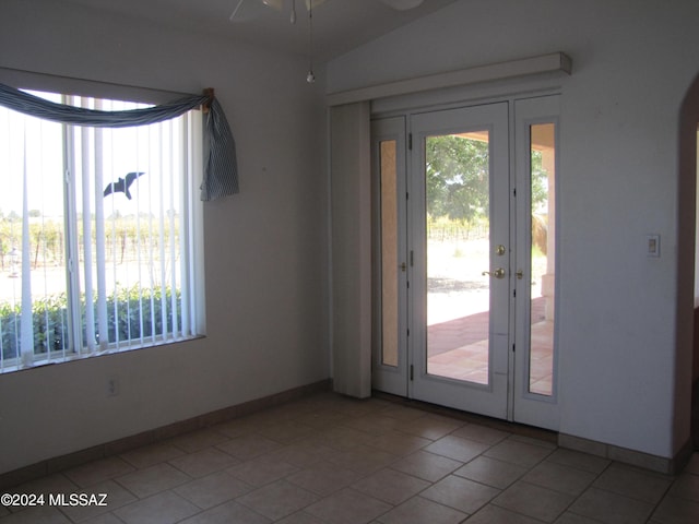 entryway with ceiling fan, tile patterned floors, and a wealth of natural light