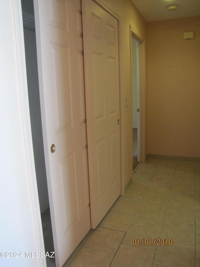 corridor with light tile patterned floors