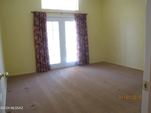 empty room with light carpet and french doors