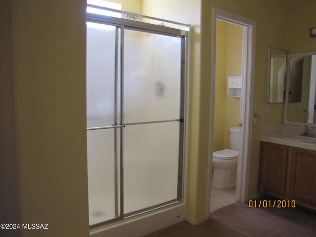 bathroom with vanity, toilet, and an enclosed shower