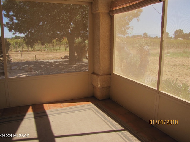 unfurnished sunroom with a rural view