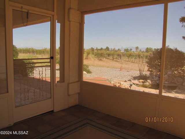 entryway featuring plenty of natural light and a rural view