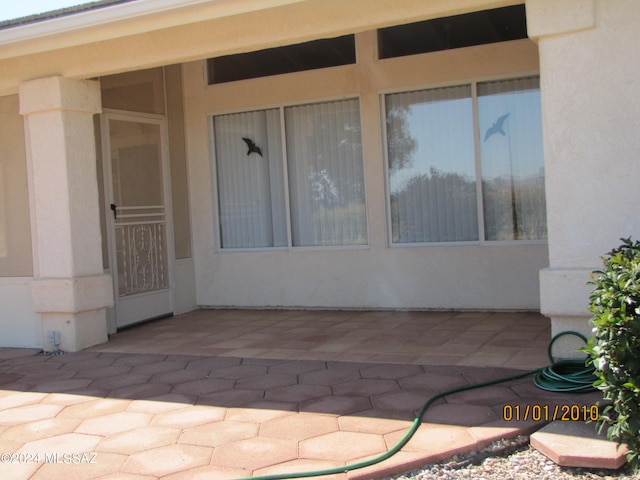 entrance to property with a patio