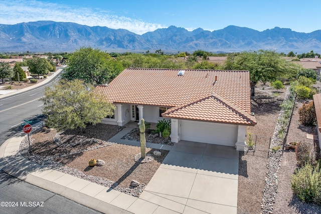 view of front of house with a mountain view and a garage