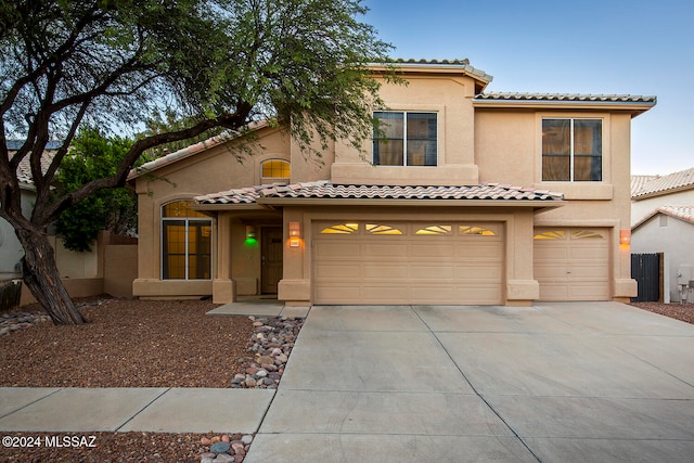 mediterranean / spanish house featuring a garage