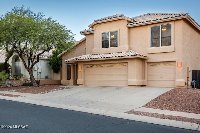 mediterranean / spanish-style home with a garage