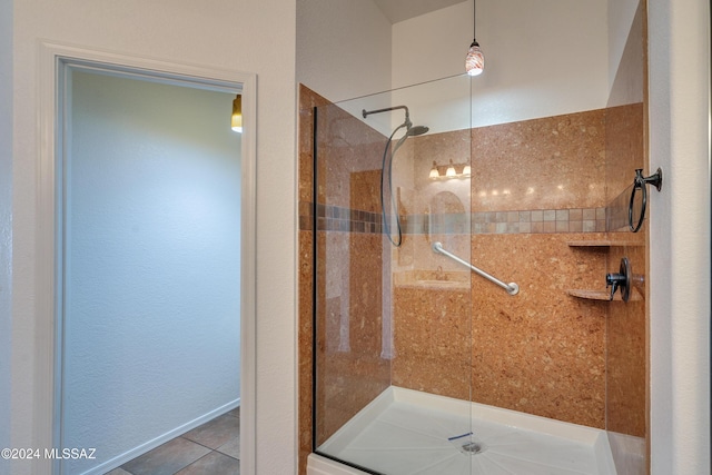 bathroom featuring tile patterned floors and a shower with shower door