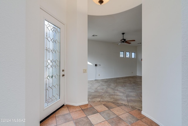 foyer with ceiling fan and light tile patterned floors