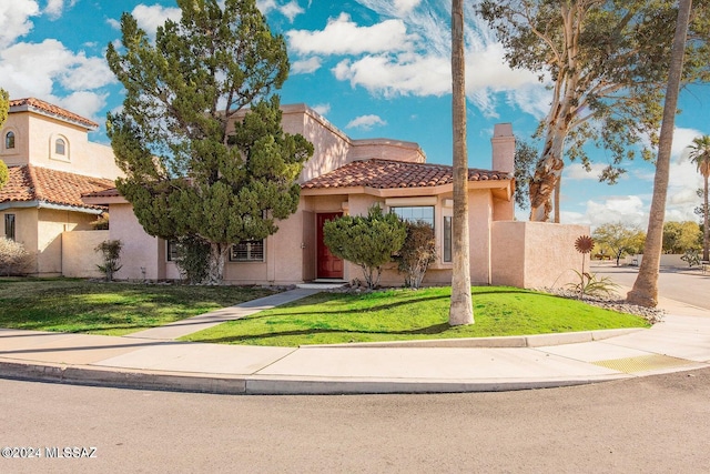 mediterranean / spanish-style home with a front lawn